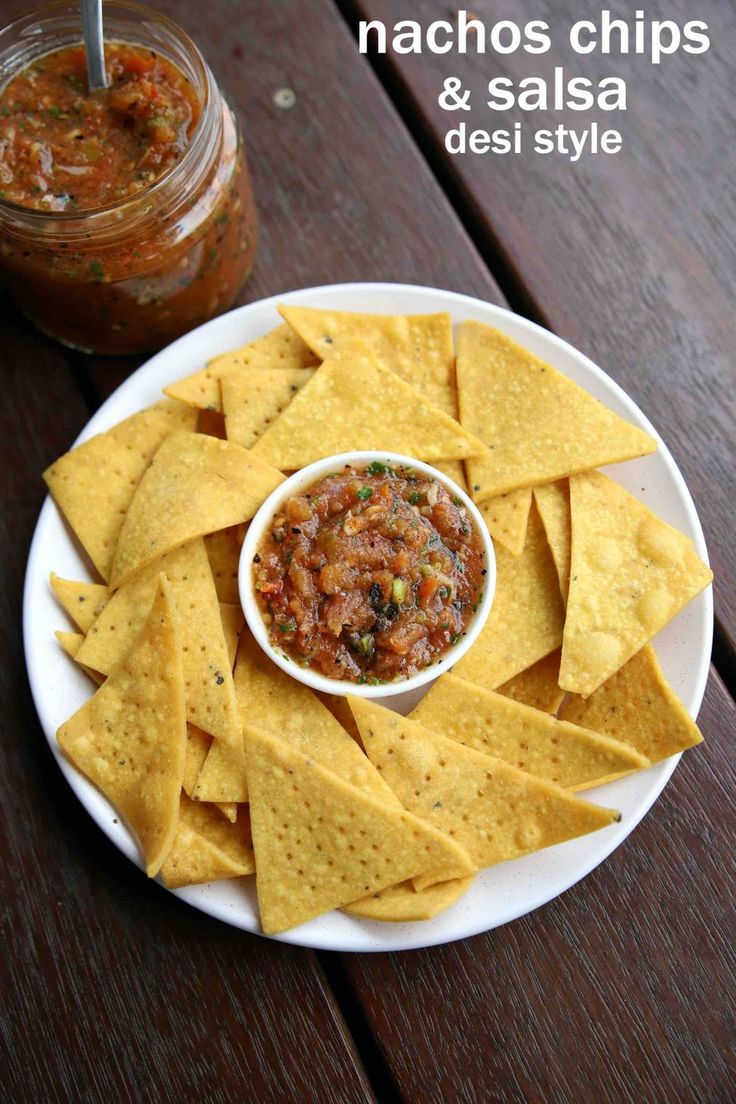 nachos chips and salsa on a white plate