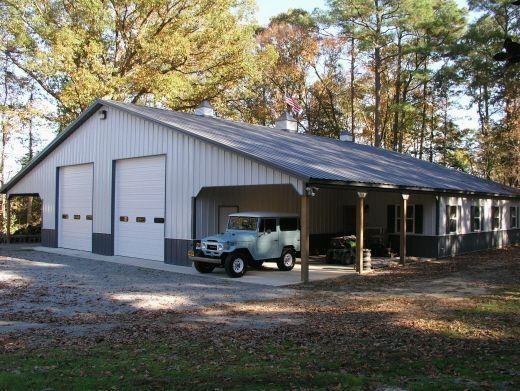 a truck is parked in front of a garage that has a carport attached to it