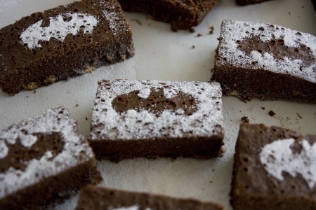 several pieces of brownie with powdered sugar on top