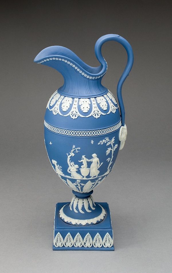 a blue and white vase sitting on top of a table