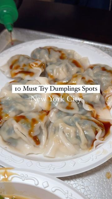 some dumplings are sitting on a white plate