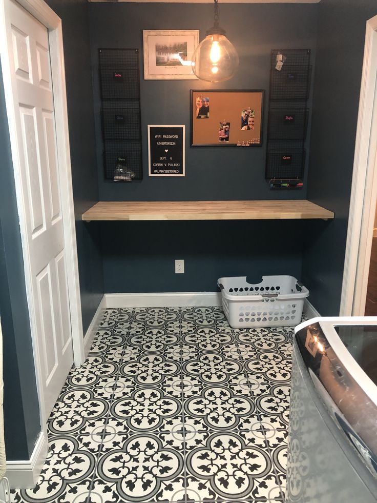 a bathroom with black and white tile flooring