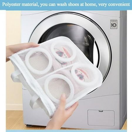 a person holding a mesh bag over a washing machine