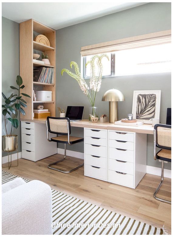 a home office with white cabinets and drawers