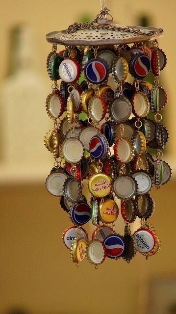 a bottle cap chandelier hanging from a ceiling