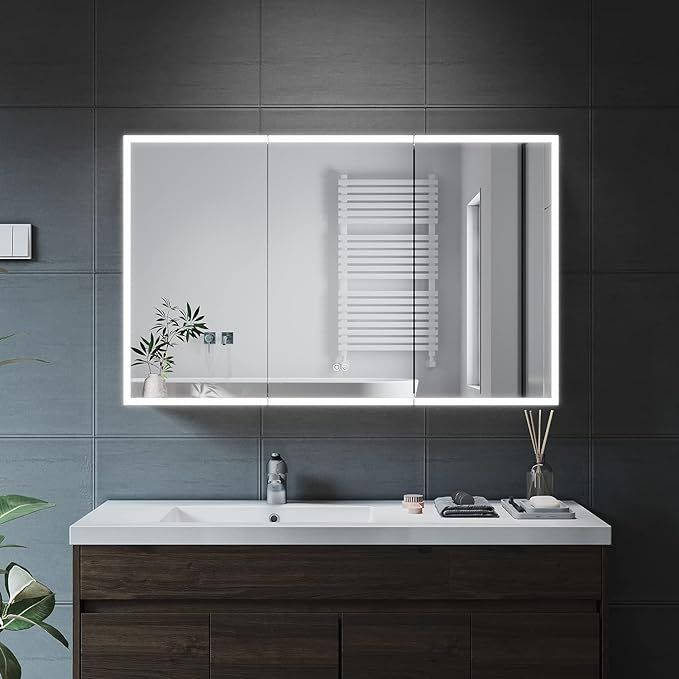 a bathroom with a sink, mirror and plants on the counter in front of it