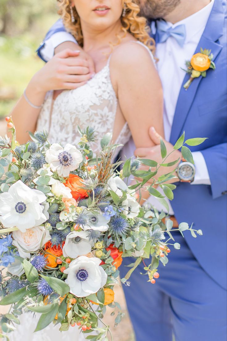 the bride and groom are embracing each other