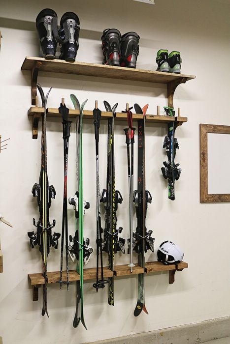 the skis are lined up on the shelves in the room and ready to be used