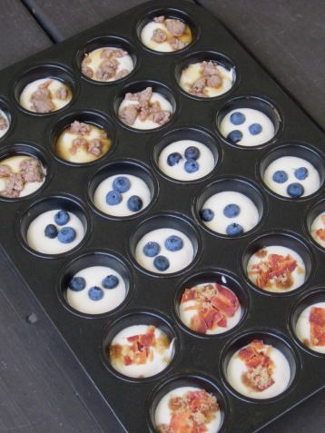 a muffin tin with blueberries and yogurt in it that is ready to be eaten