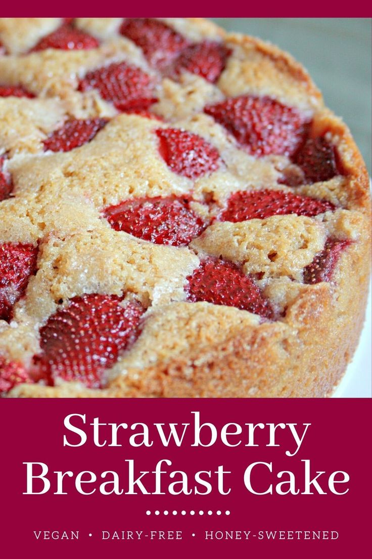 a close up of a cake with strawberries on it and the words strawberry breakfast cake