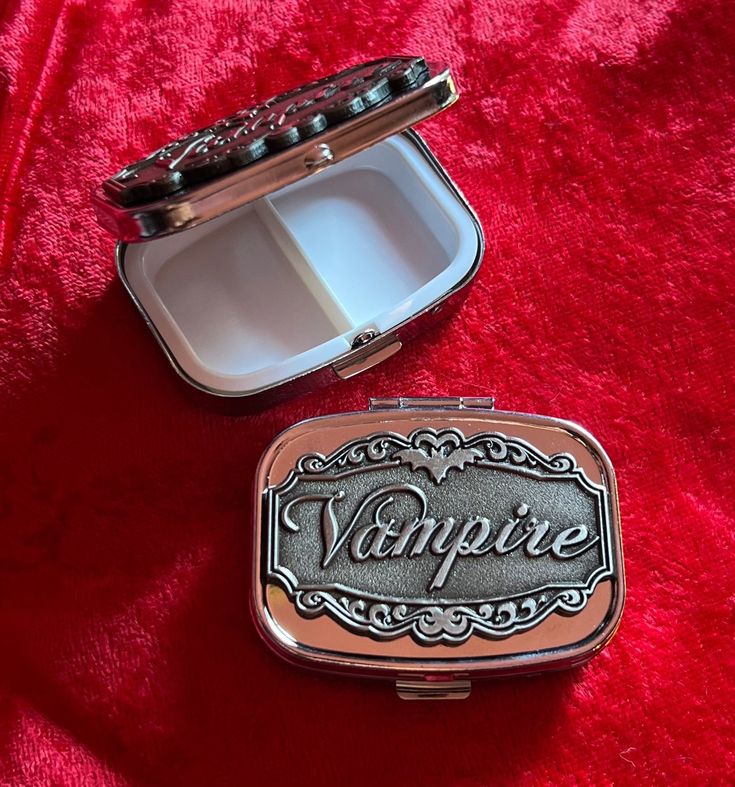 "Silver plated with plastic interior. Enamel \"Vampire\" plate on top.  Rectangle Silver Tone 1.77\" x 1.38\" x 0.59\" For storing small items, medicine. Plastic insert can not be removed.  Capsule Box Container Storage Travel Please note that Etsy will sometimes overcharge for multiple items in your cart. I will always refund any extra shipping charges and mistakes the automatic shipping calculator has made. :)" Goth Trinkets, Vampire Room Aesthetic, Pill Aesthetics, Jewelry Box Aesthetic, Trinkets Aesthetic, Goth Gift Ideas, Vampire Decor, Vampire Stuff, Galaxy Gifts