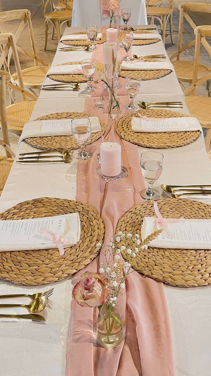 a long table set with place settings and napkins