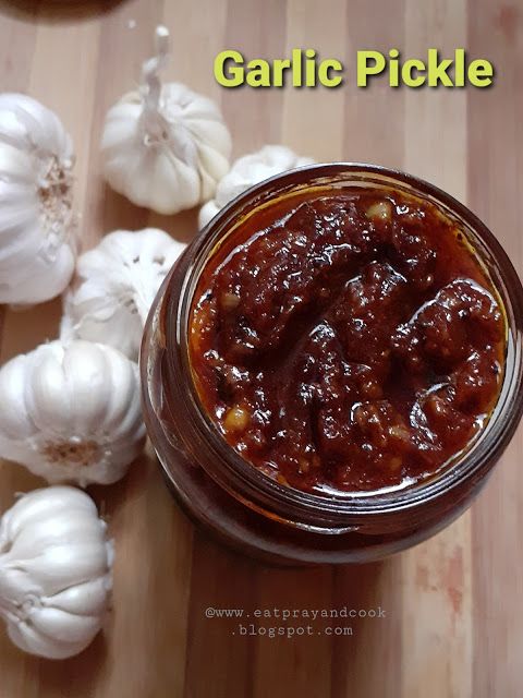 garlic pickle in a jar on a cutting board