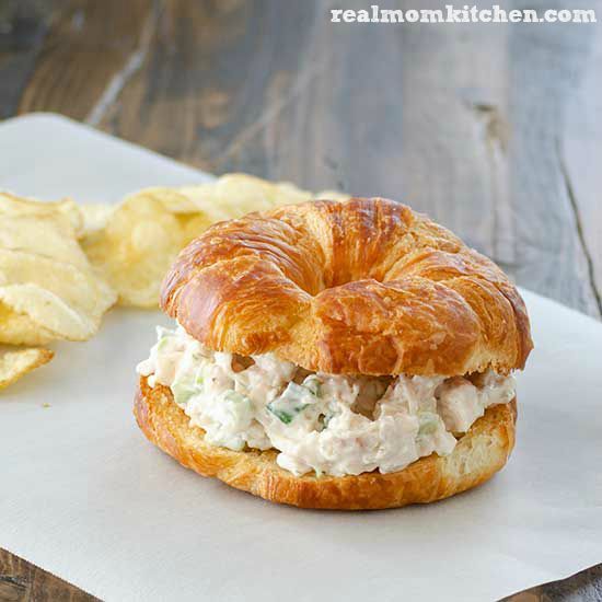 chicken salad sandwich with potato chips on the side