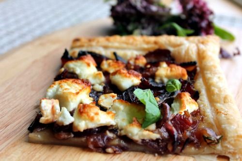 a piece of pizza sitting on top of a wooden cutting board