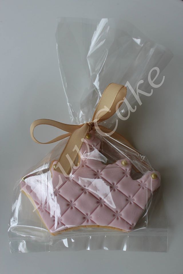 a cookie shaped like a purse is wrapped in plastic