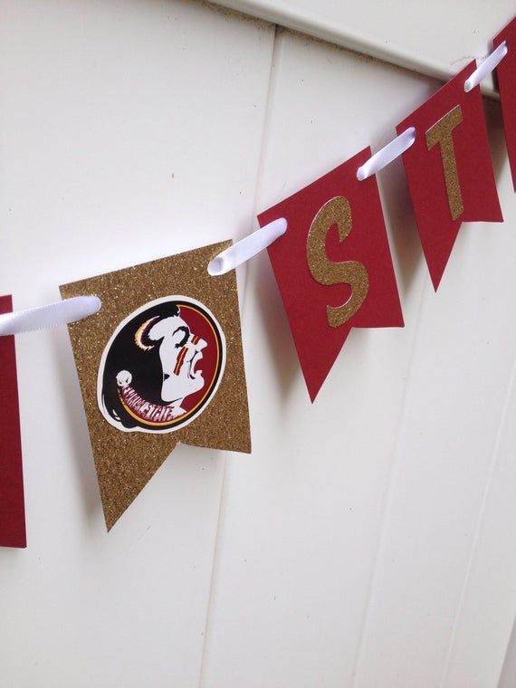 a red and gold banner that says sit on the side of a door with white trim