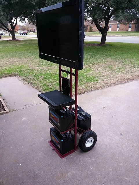 a television sitting on top of a cart