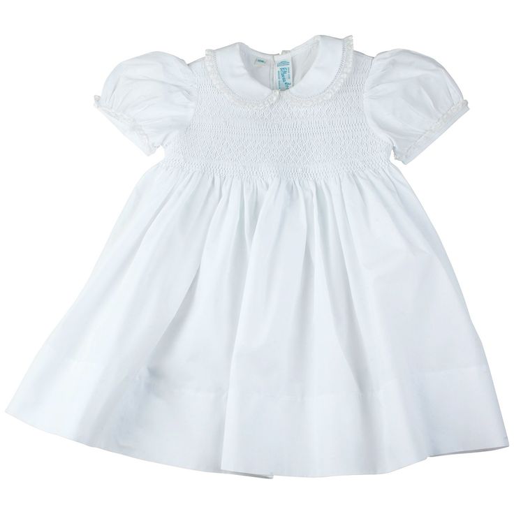 A beautiful smocked dress, unlike any other! This dainty little girls dress is a true classic with its embroidered smocked bodice, delicate fagoting, and fluted lace trim. Available in pink, white, and blue with a sweet peter pan collar and short puffed sleeves, edged with dainty fagoting and a fluted French lace trim. A classy smocked bodice features intricate hand made embroidery including a diamond overlay, soft white lines, and darling floral bullions. Ties in the back with a big classy bow Smocking Baby, Feltman Brothers, Classic Baby Clothes, Portrait Dress, Special Occasion Gowns, Yoke Dress, Bolero Dress, Girls Easter Dresses, Baptism Dress