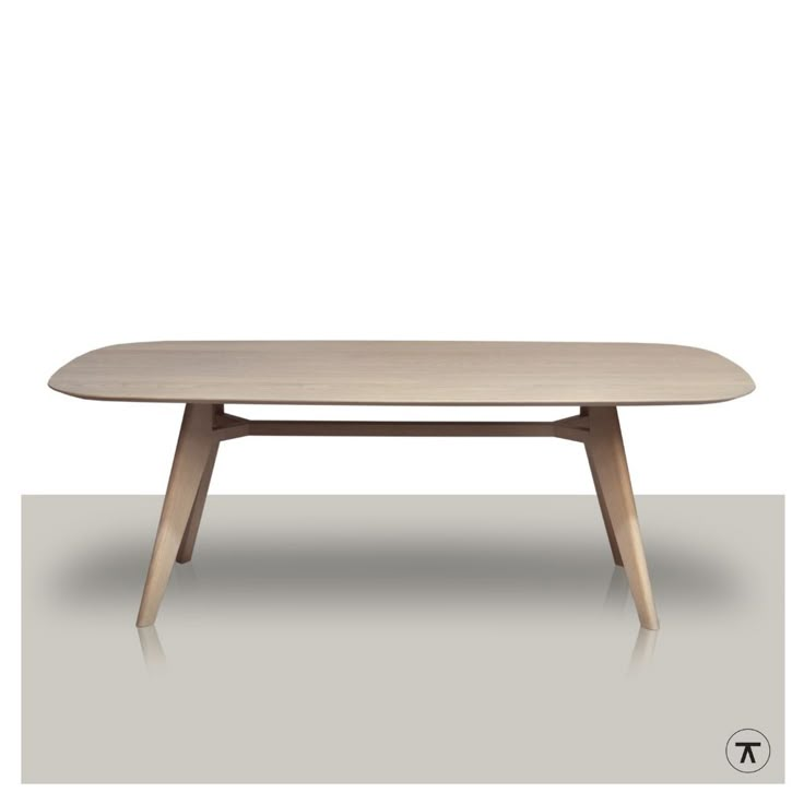 an oval table with wooden legs and a white top, on a gray surface in front of