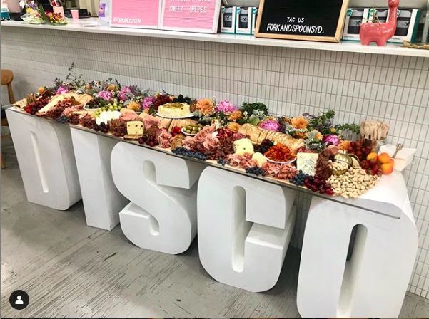 a display in a store filled with lots of different types of food on top of letters