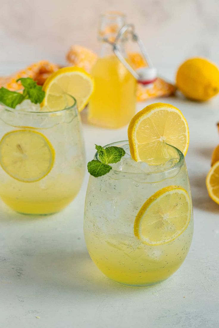 three glasses filled with lemonade and mint garnish