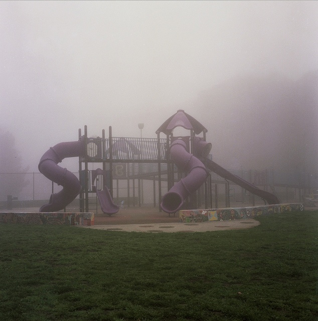 a foggy playground with slide and play equipment