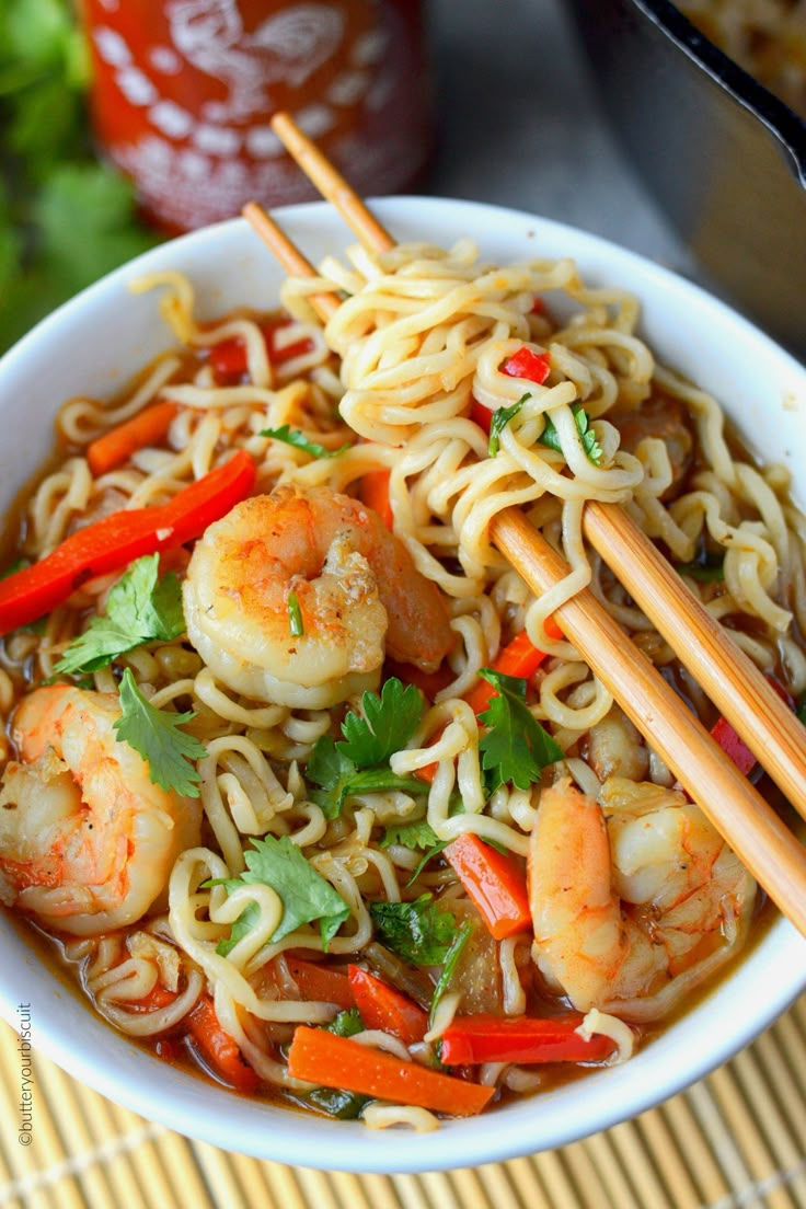 shrimp and noodle soup with chopsticks in a white bowl