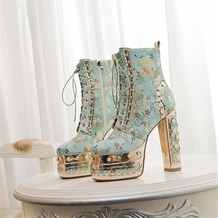 Mix your fashion streetwear with a royal twist in these chunky ankle boots. Boots features a luxe embroidered baroque-style floral print, with a metallic platform sole and chunky heel, accented with pearls, square too and lace- up with side zipper closure. Heel height 5 inches, platform height 3 inches. Cutie Aesthetic, Popular Boots, Dr Shoes, Cute Shoes Heels, Square Toe Heels, Fancy Shoes, Super High Heels, Stylish Boots, Platform Ankle Boots