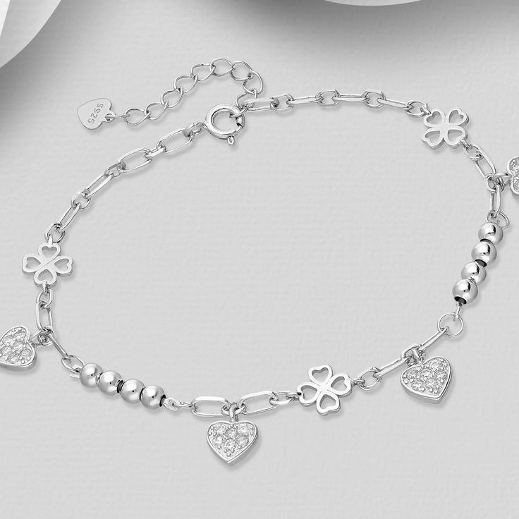 Elevate your elegance with our 925 Sterling Silver Clover Bracelet, featuring a heart design and sparkling CZ diamonds. Adjustable for perfect fit. Bracelet Length: 6½ - 7½" Fine Jewelry White Gold Heart Bracelet With Cubic Zirconia, Fine Jewelry Silver Heart Diamond Bracelet, Fine Sterling Silver Bracelet With Sparkling Stones, Elegant White Gold Charm Bracelet For Valentine's Day, Classic Silver Heart Bracelet With Cubic Zirconia, Elegant Sterling Silver Heart-shaped Charm Bracelet, Silver Heart Bracelet For Wedding, Silver Heart Bracelet For Wedding, Fine Jewelry, Classic Silver Cubic Zirconia Heart Bracelet