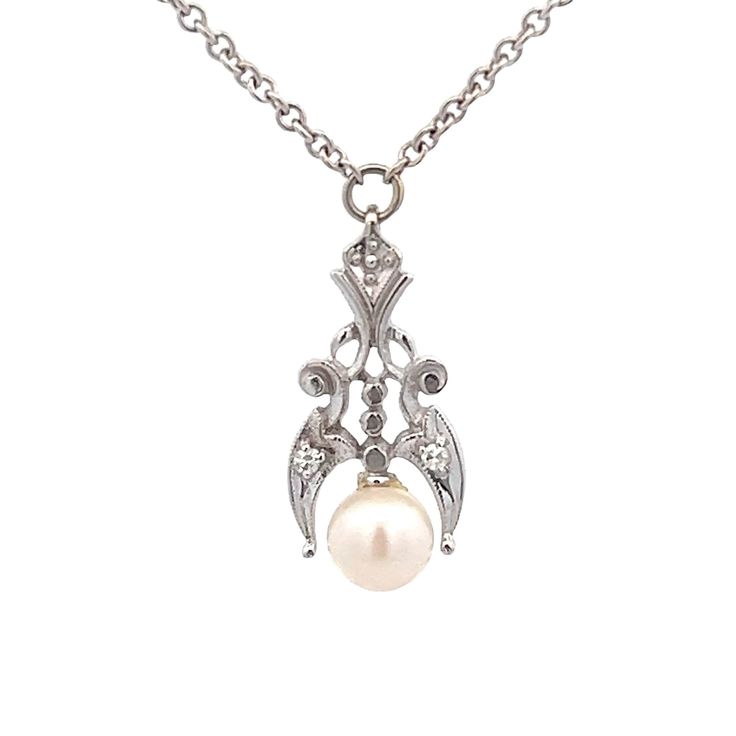 "A pearl and diamond pendant. Set at the bottom of the pendant is a round pearl. Prong set with (2) single cut diamond accents. The pendant has a geometric design. The pendant if fixed in the center of a 15\" long cable chain with spring ring closure. Metal Content Guaranteed 14k white gold Weight: 4.3 grams Stone Information Type: Cultured Pearl 5.5-6mm in diameter Type: Diamond (2) Cut: Single Cut Carat Total Weight (Calculated): 0.028cttw Color/Clarity: H-I / SI average Measurements of pendan Antique White Gold Necklace With Pearl Pendant, Vintage Diamond White Pendant Necklace, Victorian Pearl Drop Necklace For Formal Occasions, Formal Antique Pearl Drop Necklace, Victorian Diamond Jewelry With Pearl Pendant, Victorian White Gold Jewelry With Pearl Pendant, Classic Diamond Necklace With Pearl Chain For Weddings, Classic Wedding Diamond Necklace With Pearl Chain, Antique Pearl Necklace With Pearl Pendant For Formal Occasions