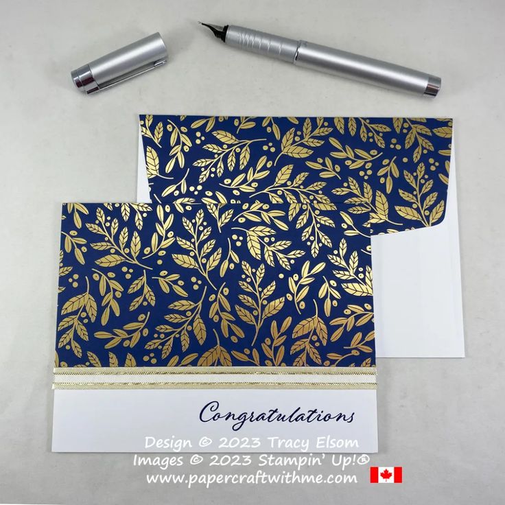 two cards with gold leaves on them next to a fountain pen and paper that says congratulations