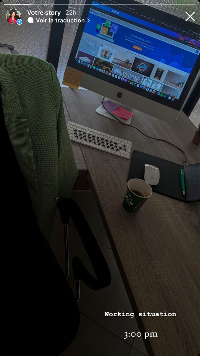 a computer monitor sitting on top of a wooden desk next to a keyboard and mouse