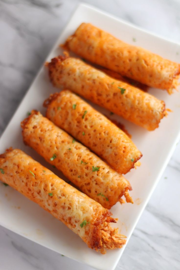 some food is on a white plate and ready to be eaten with chopsticks