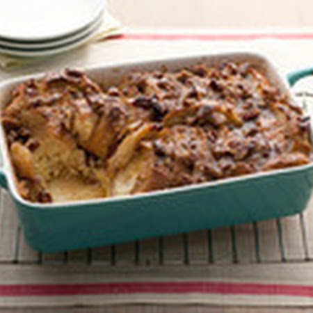 a blue casserole dish filled with food sitting on top of a cooling rack