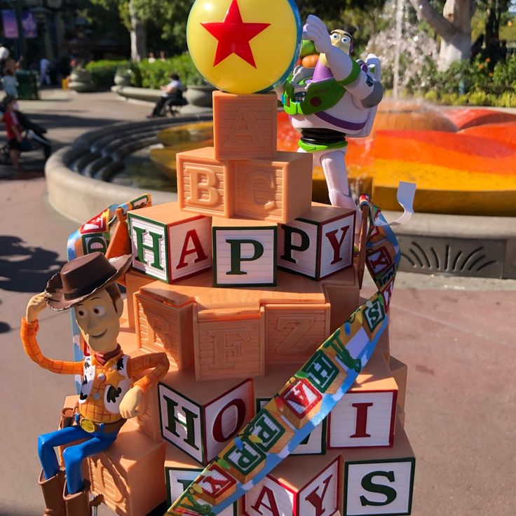 a toy story birthday cake with woody and friends on top