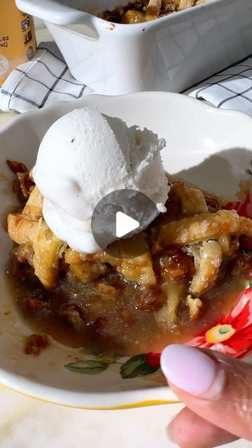 a person holding up a piece of pie with ice cream on top in front of two bowls