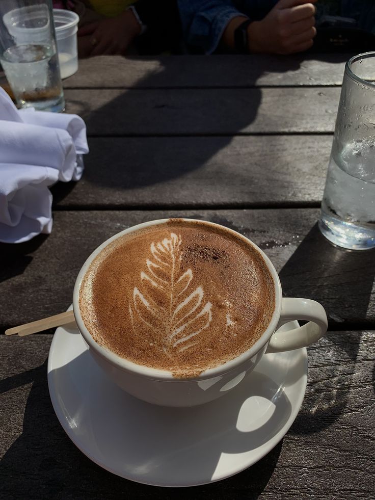 a cappuccino with a leaf drawn on it