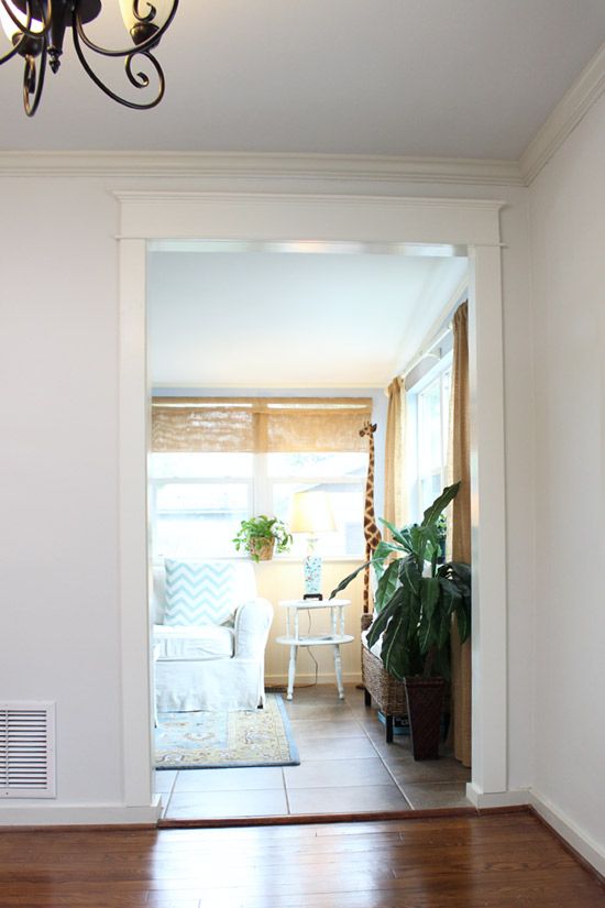 a living room with hard wood floors and white walls