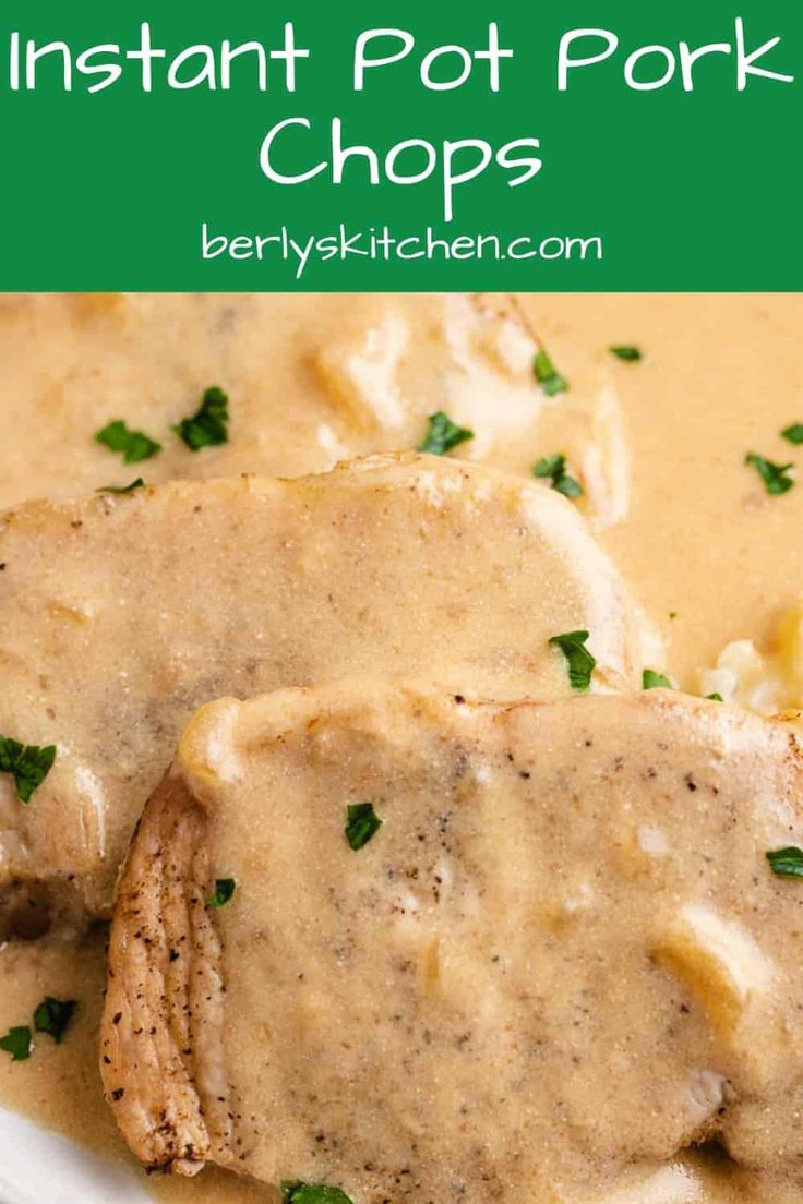 two pork chops covered in gravy and garnished with parsley