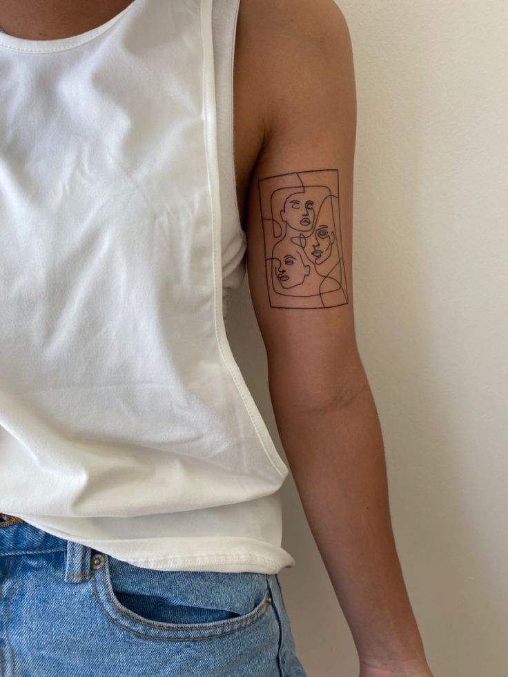 a woman's arm with a tattoo on the left side of her right arm