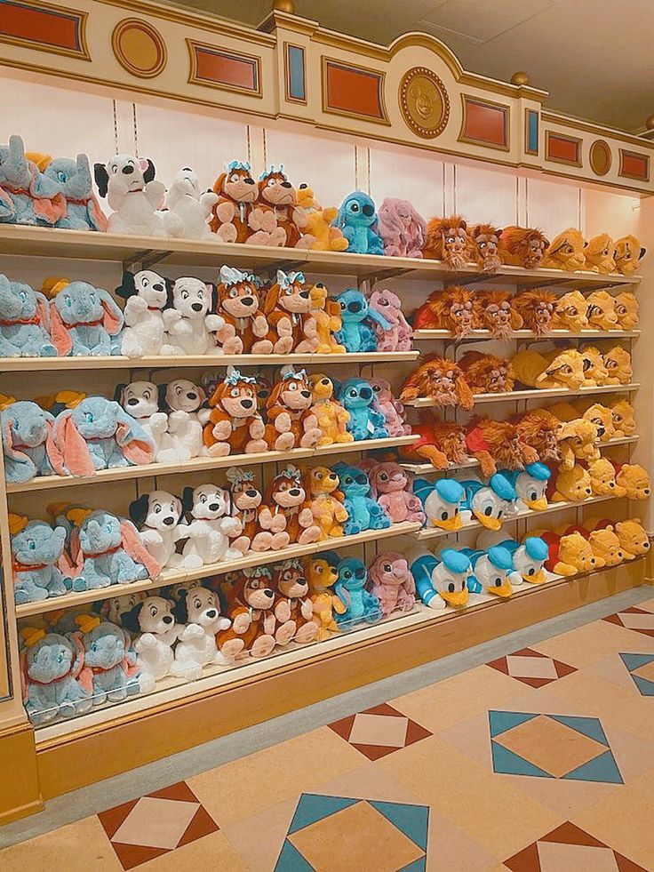 many stuffed animals are on display in the store's shelving area, including winnie the pooh