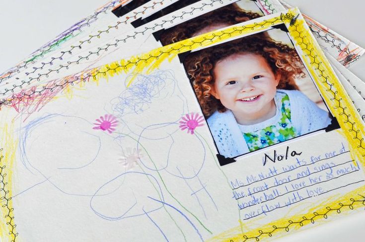 a child's photo is placed on top of an album with flowers and leaves