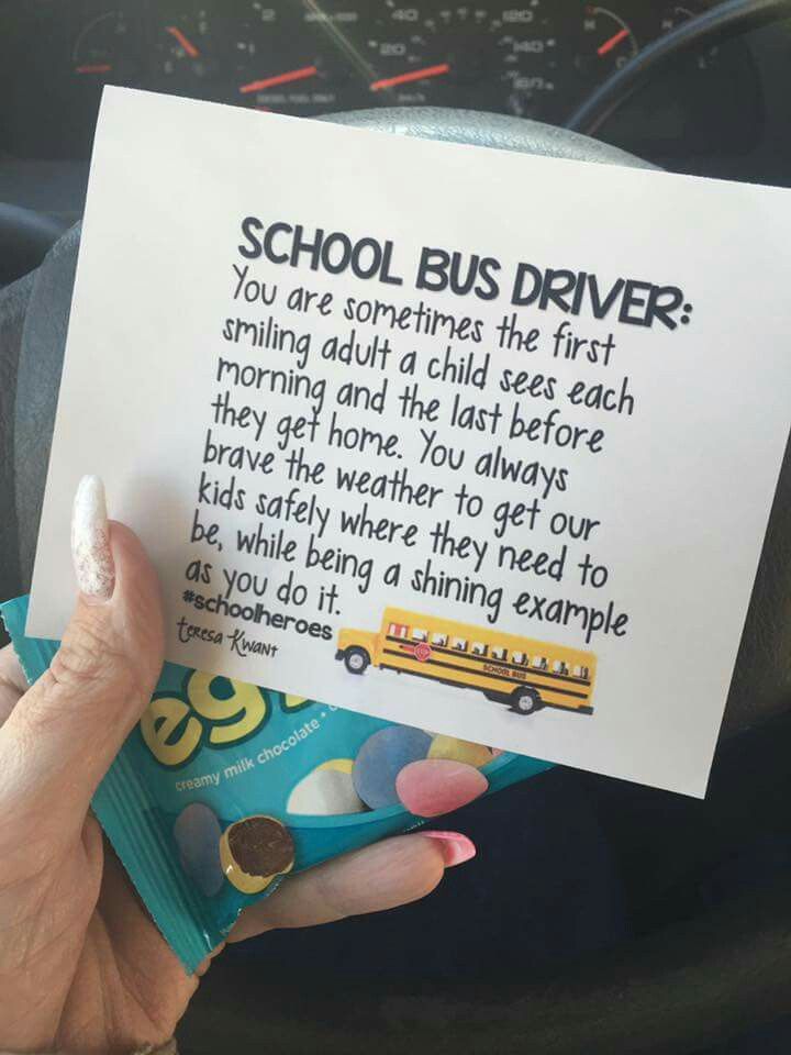 a person holding up a school bus driver's note to someone in the car