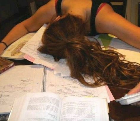 a woman laying on top of an open book