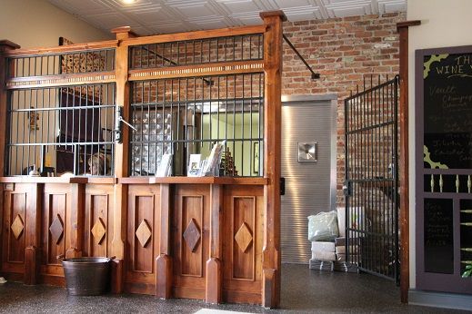 the inside of a building with wooden doors and metal bars on each side of it