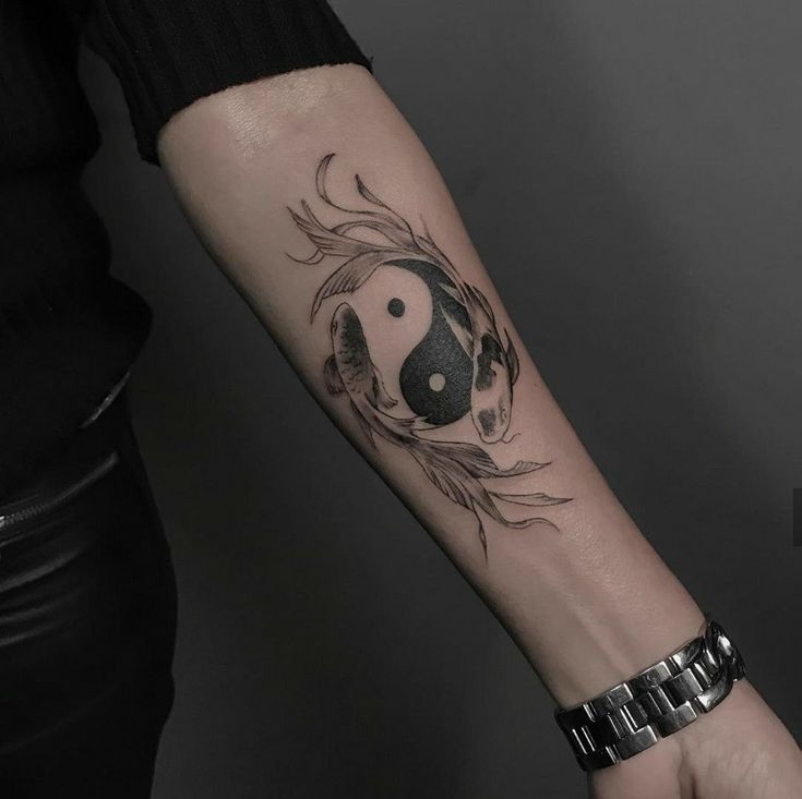 a woman's arm with a tattoo on it that has a black and white panda