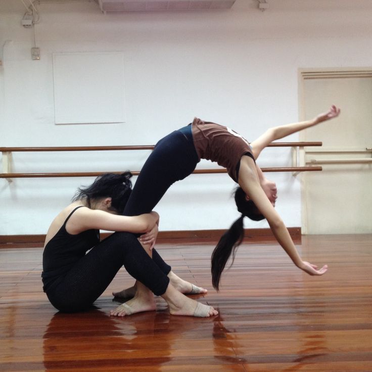 two dancers in a dance studio, one holding the other upside down