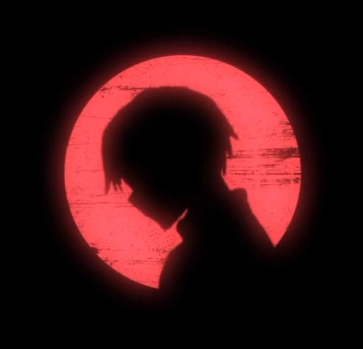 the silhouette of a person in front of a red circle