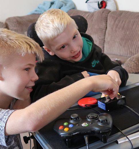 two young boys playing video games on the nintendo wii